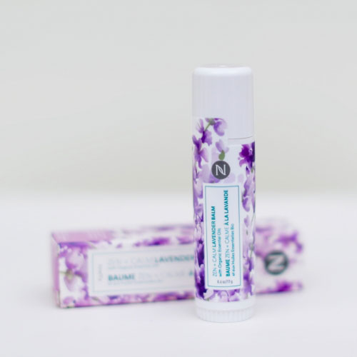 Neora’s Holiday Hot List must-have, Zen + Calm Lavender Balm, laying on a countertop.